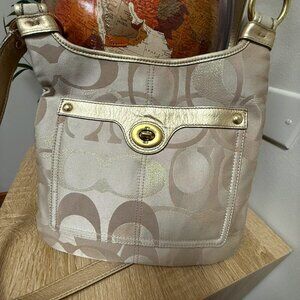 Coach Penelope F18478 Tan and gold crossbody bag with Turnlock detail.